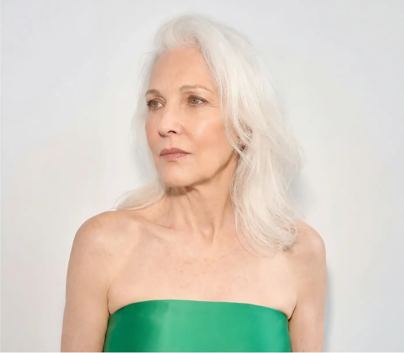 Close-up portrait of a woman in an emerald green dress